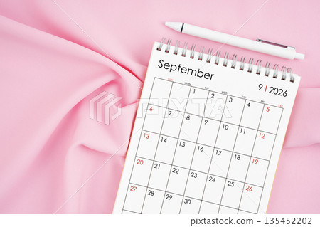 September 2026 month calendar and pen on pink fabric background. September 2026 month calendar and pen on pink fabric background. 135452202