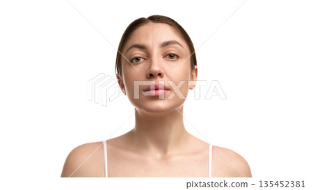Front view female portrait with natural skin and direct gaze. Front view female portrait with natural skin and direct gaze. 135452381
