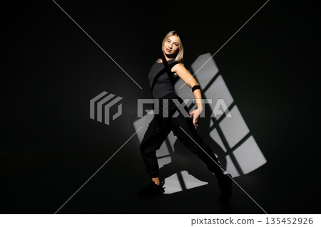 Young dancer performing with window-shaped shades on background Young dancer performing with window-shaped shades on background 135452926