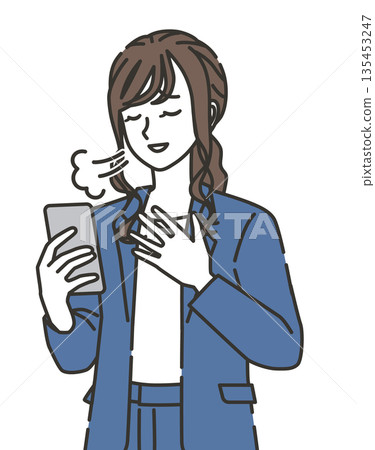 A woman in office casual clothes looking at her smartphone with relief A woman in office casual clothes looking at her smartphone with relief 135453247