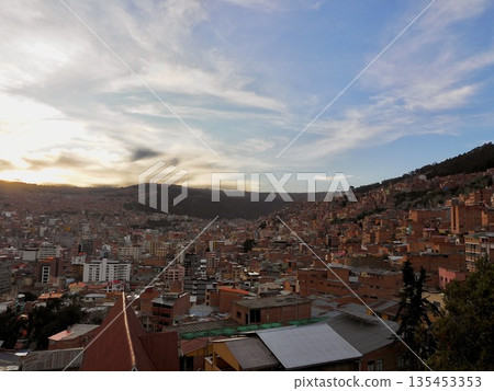 Cityscape at dusk seen from a hill Cityscape at dusk seen from a hill 135453353