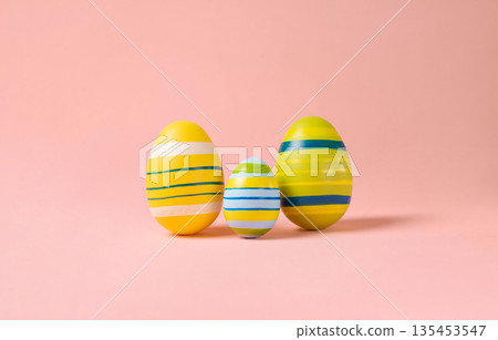 Minimal Easter layout with colorful eggs on a pink background. Easter family eggs . creative concepts. Easter card with copy space for text. 135453547