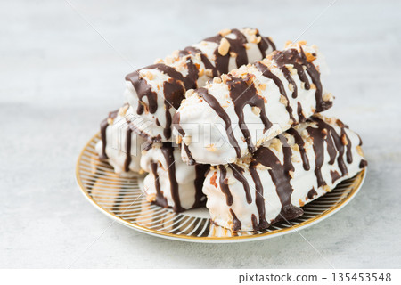 butter cookies dessert covered in chocolate and walnut glaze on gray table 135453548