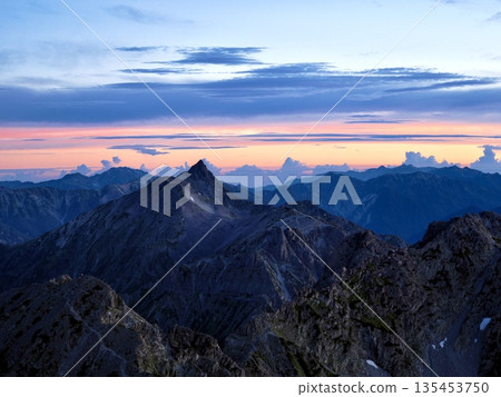 View of Mt. Karasawa, Mt. Okirito, and Mt. Yari in the morning glow from Mt. Okuhotaka 135453750