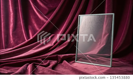 Elegant mirror reflecting draped velvet fabric in deep red Elegant mirror reflecting draped velvet fabric in deep red 135453880