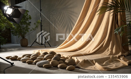 Studio scene with flowing tan curtain stones and professional lighting Studio scene with flowing tan curtain stones and professional lighting 135453906