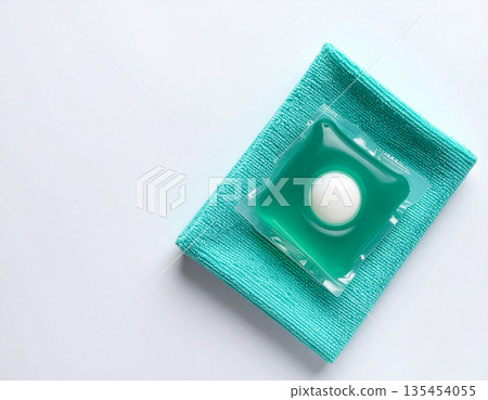 Hygiene concept. Soluble laundry detergent capsule on a neutral linen cloth with empty space for text. 135454055