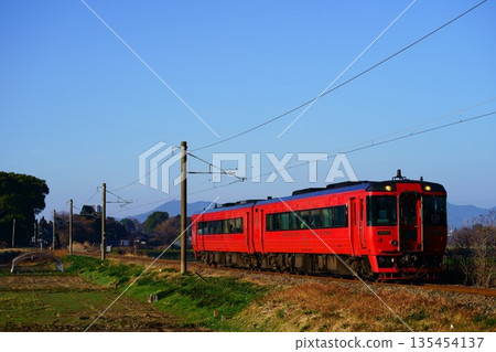 Kyushu Trans-Kyushu Express train running through the countryside of Kikuyo Town 135454137