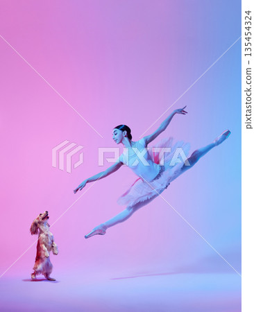 Ballerina jumping with small dog on colorful studio background collage. 135454324