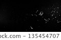Side angle photo of flying shattered glass shards and dust isolated on black background. High detail debris explosion, perfect for VFX overlay, compositing, transitions or dramatic design elements. 135454707