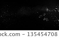 Side angle photo of flying shattered glass shards and dust isolated on black background. High detail debris explosion, perfect for VFX overlay, compositing, transitions or dramatic design elements. 135454708
