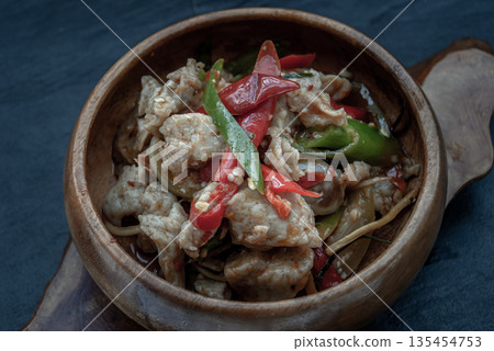 Thai Spicy food, Spicy stir fried fish balls and thai herbs vegetables in wooden bowl. Thai Spicy food, Spicy stir fried fish balls and thai herbs vegetables in wooden bowl. 135454753
