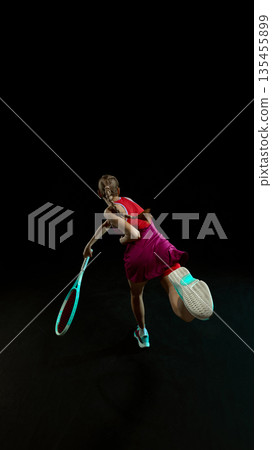 Female tennis athlete dynamic jump shot in studio scene. Female tennis athlete dynamic jump shot in studio scene. 135455899