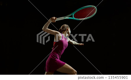 Female tennis player reaching for ball in dramatic motion. Female tennis player reaching for ball in dramatic motion. 135455901