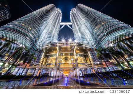 The Petronas Twin Towers and fountains, symbols of Kuala Lumpur, illuminated in the night sky The Petronas Twin Towers and fountains, symbols of Kuala Lumpur, illuminated in the night sky 135456017