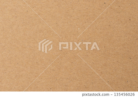 Brown paper surface used for crafts and packaging in a workspace setting Brown paper surface used for crafts and packaging in a workspace setting 135456026