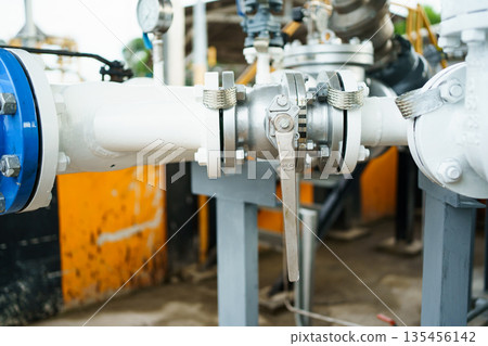 Pressure gauge on industrial pipeline with valve in factory. 135456142