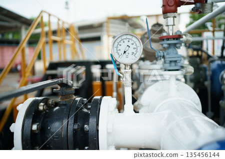 Pressure gauge on industrial pipeline with valve in factory. Pressure gauge on industrial pipeline with valve in factory. 135456144