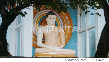 Buddha statue meditation pose in white stone with ornate halo at Rumassala Peace Temple, Galle 135456249