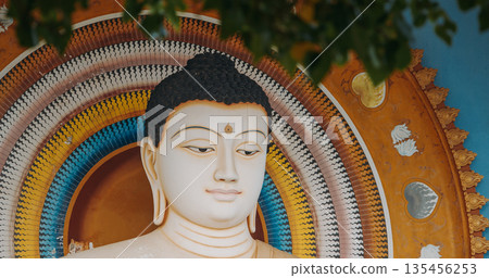 Buddha statue meditation pose in white stone with ornate halo at Rumassala Peace Temple, Galle 135456253