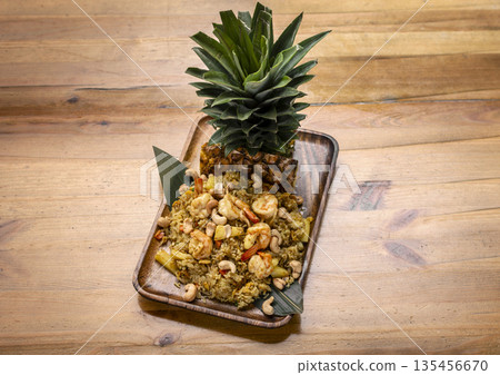 Thai chicken fried rice with pineapple and cashew on modrn bangkok restaurant table in thailand Thai chicken fried rice with pineapple and cashew on modrn bangkok restaurant table in thailand 135456670