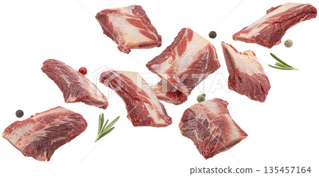 Falling raw beef rib pieces isolated on white background, fresh meat cuts ideal for soup, broth, stew, butcher packaging and meat advertising, full depth of field 135457164