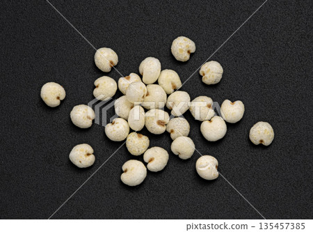 Puffed millet pile isolated on black background, cereal breakfast grains, top view, full depth of field Puffed millet pile isolated on black background, cereal breakfast grains, top view, full depth of field 135457385