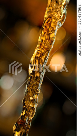 Pouring Whiskey from Bottle . Stream of Golden Liquid Flows on a Pub Pouring Whiskey from Bottle . Stream of Golden Liquid Flows on a Pub 135457668