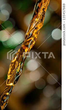 Pouring Whiskey from Bottle . Stream of Golden Liquid Flows on a Pub 135457669