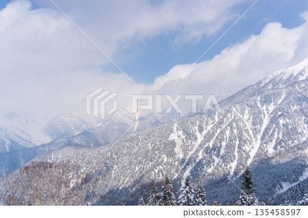 Winter new rice harvest Snow-covered mountain range scenery 135458597