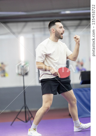 Male athlete celebrating table tennis victory Male athlete celebrating table tennis victory 135458722