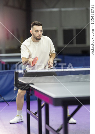 Male player focusing on table tennis game Male player focusing on table tennis game 135458782
