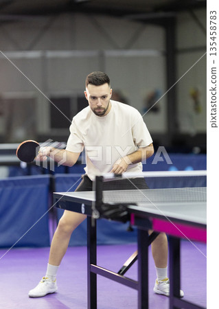 Young man playing table tennis racket sport activity Young man playing table tennis racket sport activity 135458783