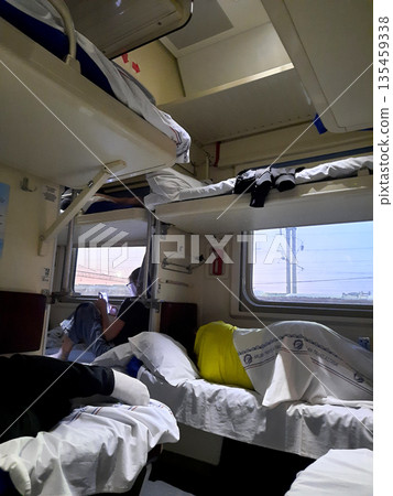 Interior of a sleeping car of a train with passengers. 135459338
