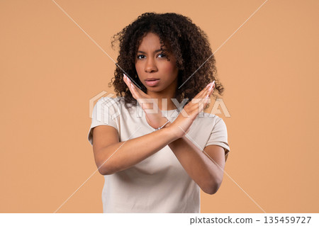 Serious Woman - Crossed Hands In Stop Forbidden Gesture, Assertive Body Language Serious Woman - Crossed Hands In Stop Forbidden Gesture, Assertive Body Language 135459727
