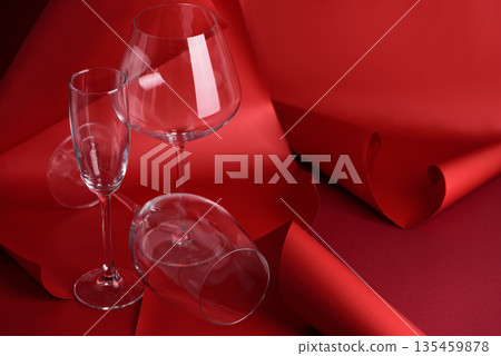 Three Wine Glasses on Sculptural Red Background. Artistic Still Life with Transparency and Form Three Wine Glasses on Sculptural Red Background. Artistic Still Life with Transparency and Form 135459878