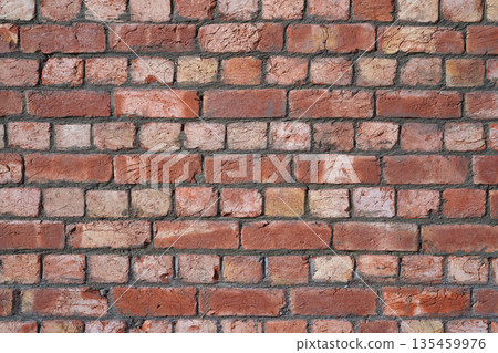 Brick wall. Industrial textured background. Red hand-molded bricks, with visible layers of clay and a rough texture, freshly laid in cement mortar. Careful masonry of uneven bricks. Brick wall. Industrial textured background. Red hand-molded bricks, with visible layers of clay and a rough texture, freshly laid in cement mortar. Careful masonry of uneven bricks. 135459976
