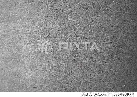 Grey concrete wall background with vertical focal point in the center. Abstract textured porous, detailed backdrop of an untreated concrete surface with horizontal perspective, slightly blurred sides 135459977