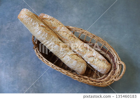French bread in a basket on a gray background French bread in a basket on a gray background 135460183