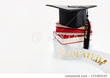 Graduation cap 2026 on books and sash Graduation cap 2026 on books and sash 135460185
