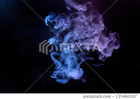 Colorful ink swirling in water creating abstract patterns 135460197