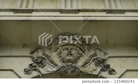 Mascaron adorning building facade, architectural detail. Action Mascaron adorning building facade, architectural detail. Action 135460241