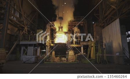 Molten metal pouring in steel mill: industrial scene. Stock clip 135460264
