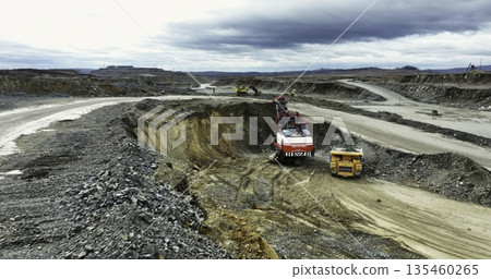 Mining truck loading minerals in open pit quarry. Stock clip Mining truck loading minerals in open pit quarry. Stock clip 135460265