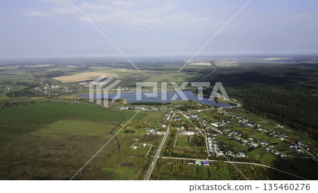 Autumn colors enhance russian countryside, showing serene lake and village. Clip Autumn colors enhance russian countryside, showing serene lake and village. Clip 135460276
