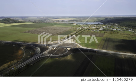 Highway interchange under construction connecting rural countryside. Clip 135460279