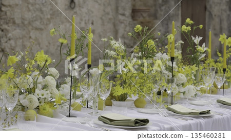 Elegant wedding table decorated with yellow flowers and lemons. Action 135460281