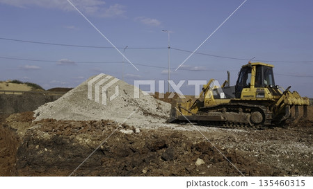 Bulldozer moving gravel on construction site under blue sky. Clip Bulldozer moving gravel on construction site under blue sky. Clip 135460315