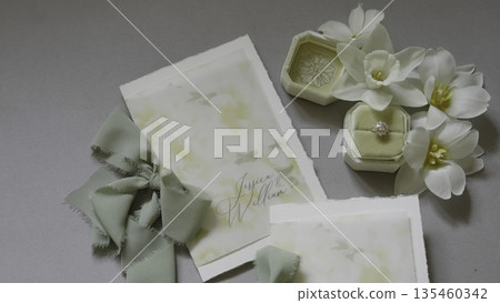 Elegant wedding stationery featuring white tulips and a diamond ring. Action Elegant wedding stationery featuring white tulips and a diamond ring. Action 135460342