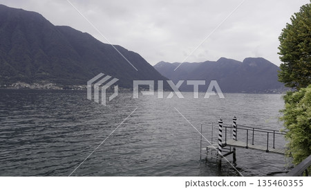 Experience a breathtaking Tranquil Lake View surrounded by majestic Mountains with a lovely Dock. Action Experience a breathtaking Tranquil Lake View surrounded by majestic Mountains with a lovely Dock. Action 135460355